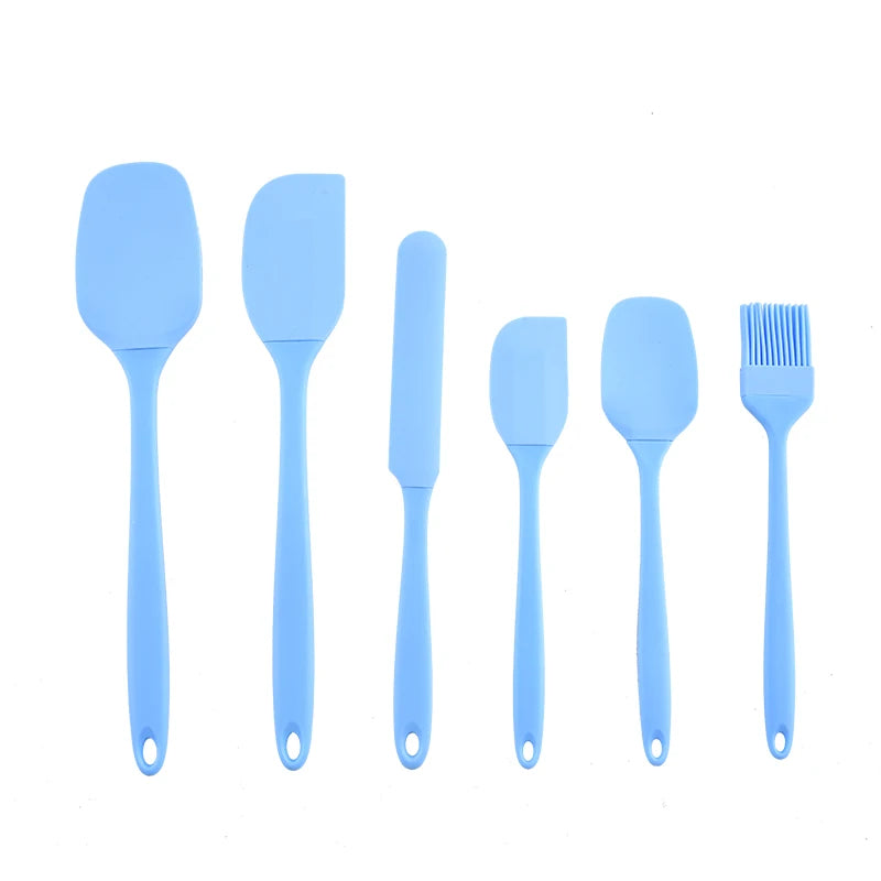 Set of blue silicone kitchen utensils on a white background