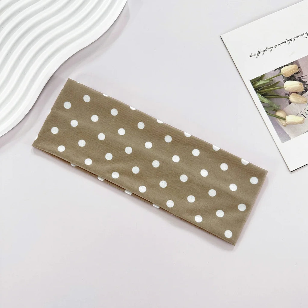 Brown fabric with white polka dots on a light gray surface