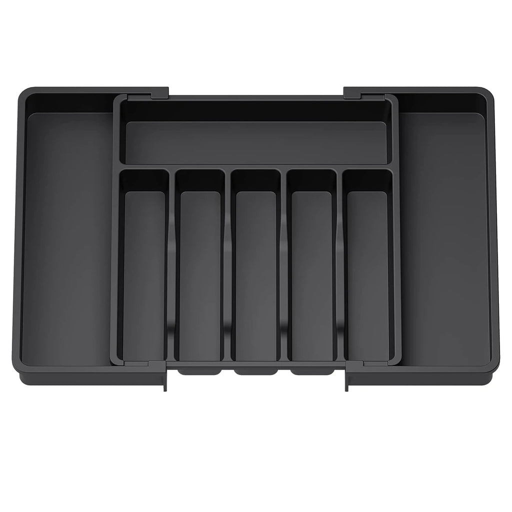 Black plastic drawer organizer with multiple compartments on a white background