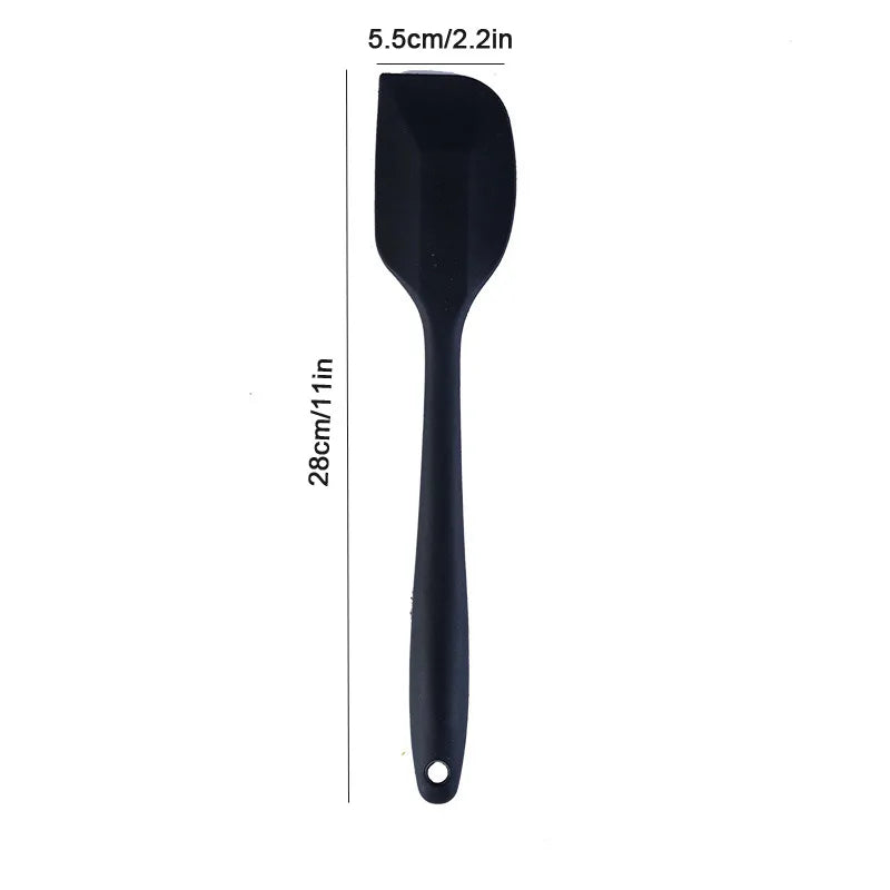 Black spatula with measurements on a white background