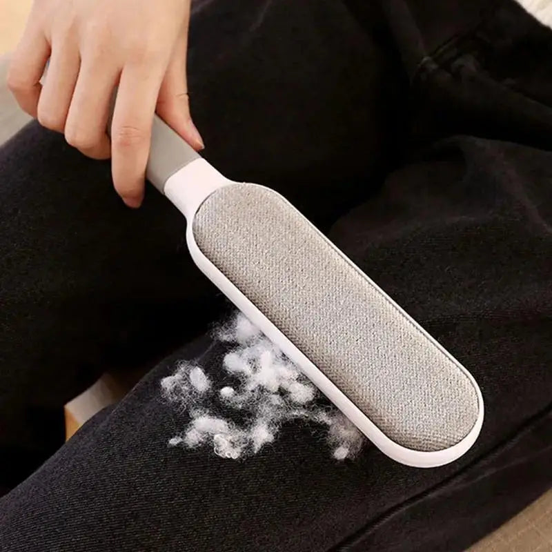 Person using a pet hair remover on dark clothing the difference is clear. 