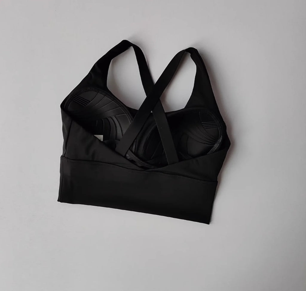 Black sports bra on a light gray background