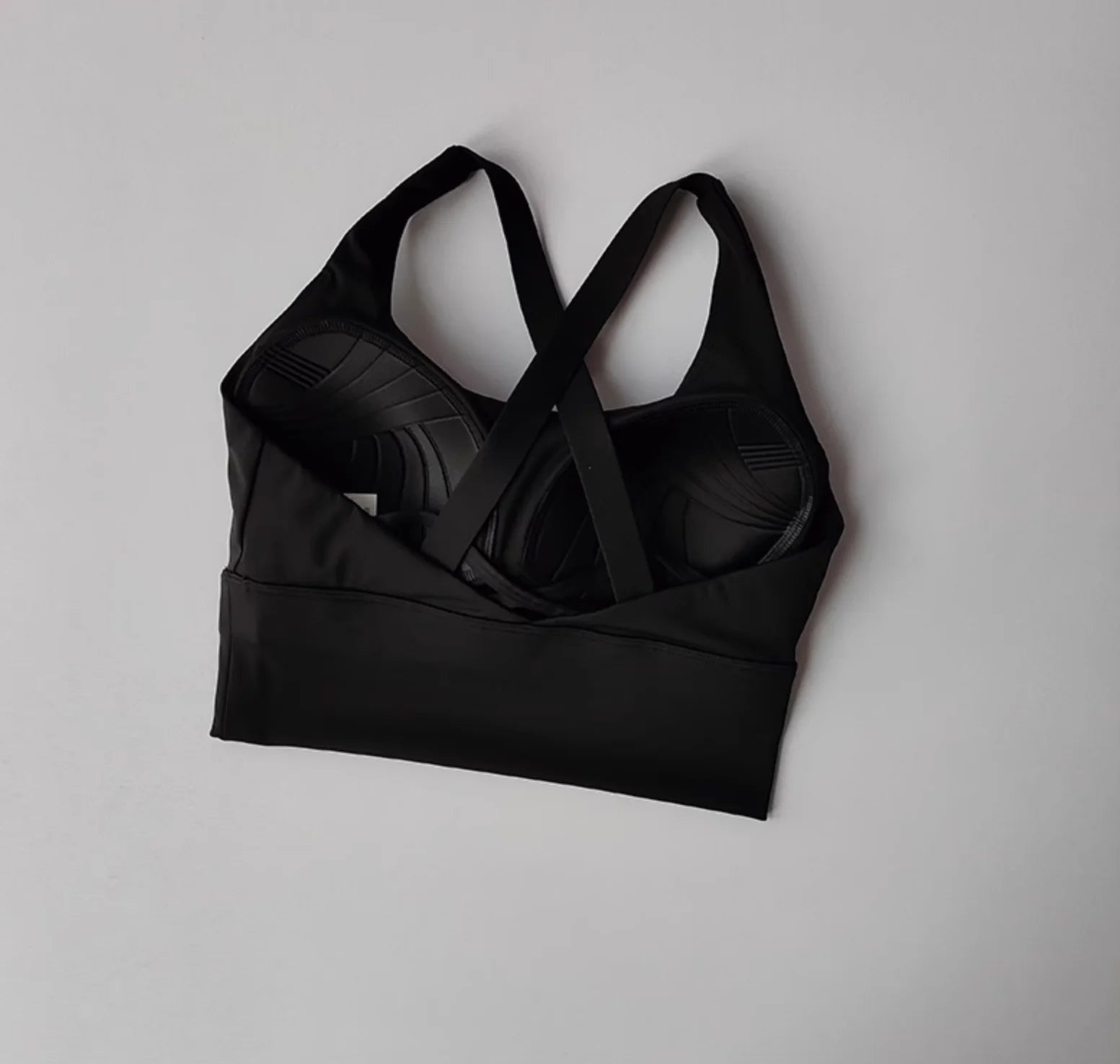 Black sports bra on a light gray background