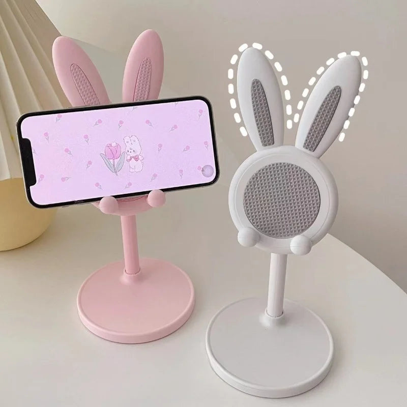 Pink and white phone stands with bunny ears.