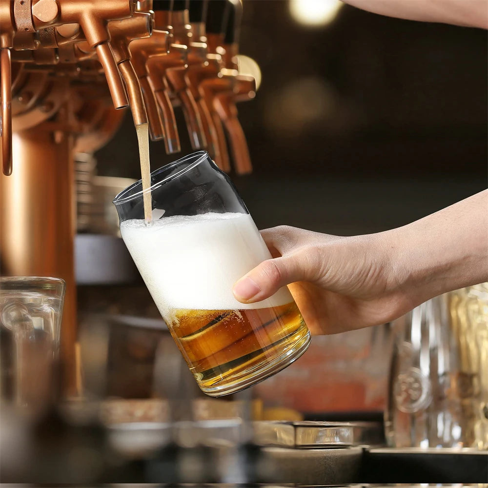 Person pouring beer from a tap into a glass at a bar.