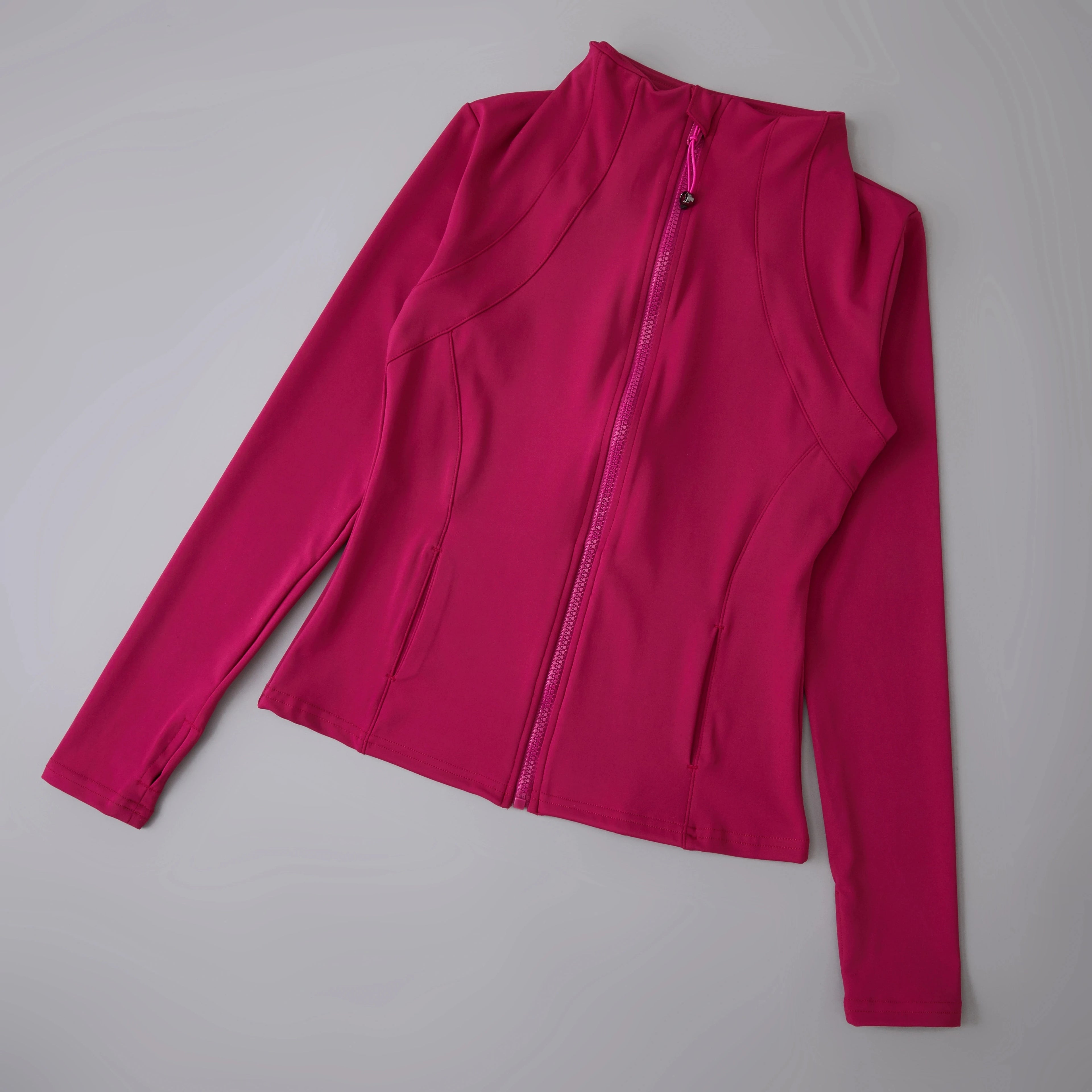 Pink long-sleeve active wear with a zipper.