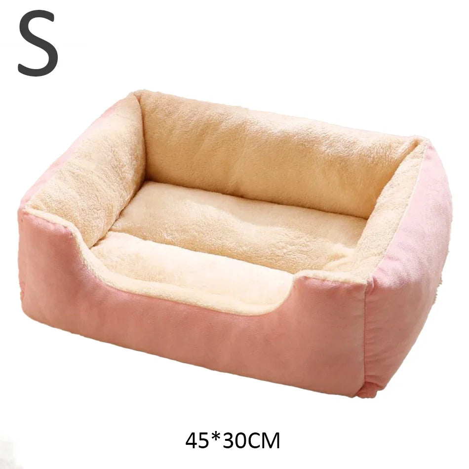 Small pet bed with pink and beige color scheme on a white background