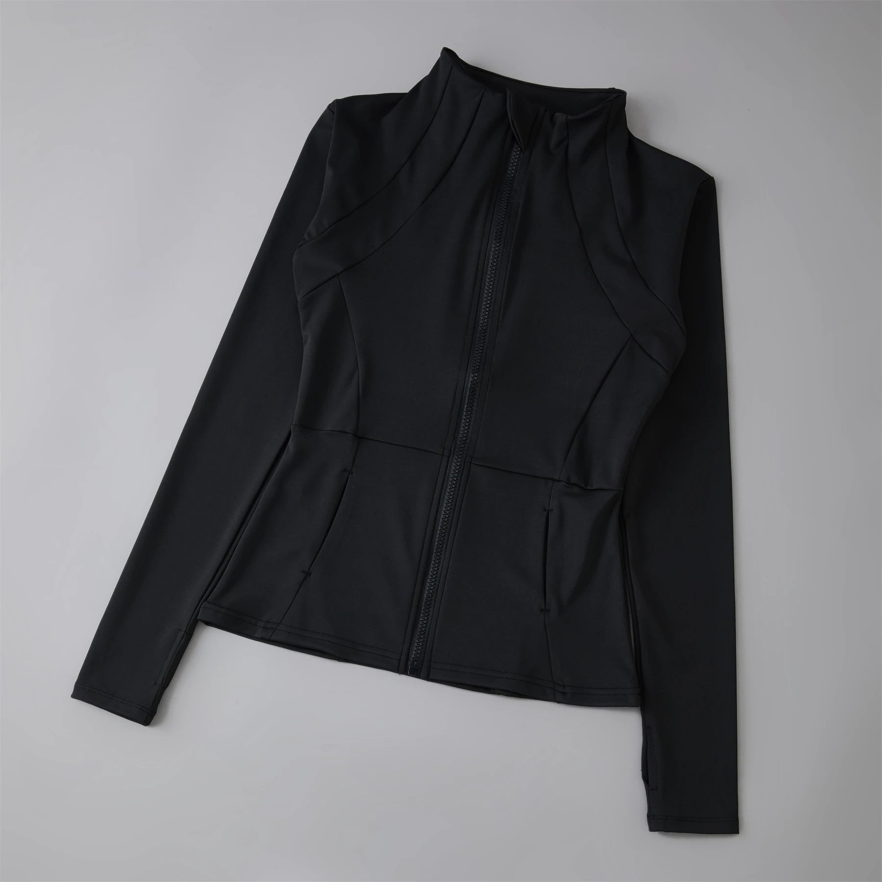 Black active wear  jacket on a light gray background
