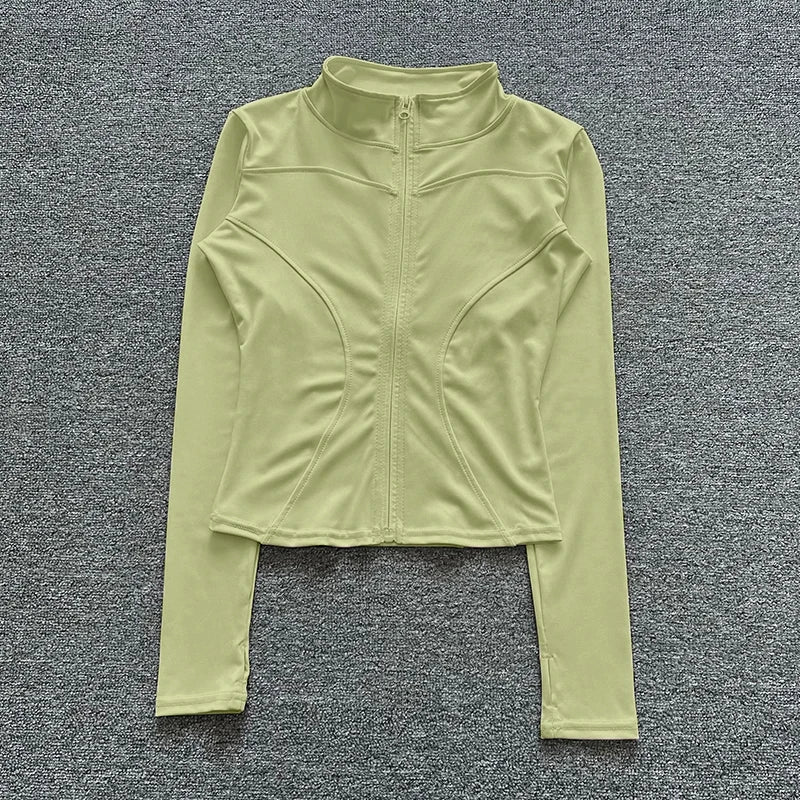 Light green long-sleeve athletic top on a gray textured background