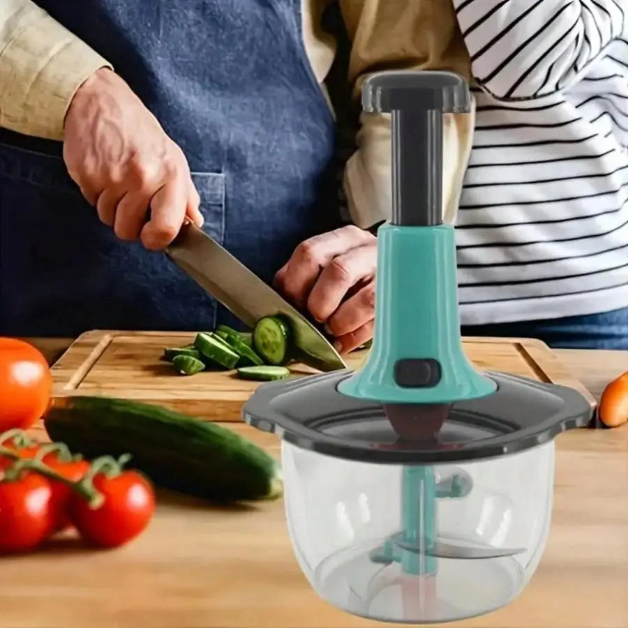 Person using a multi function vegetable and fruit chopper on a wooden cutting board with tomatoes and cucumbers.