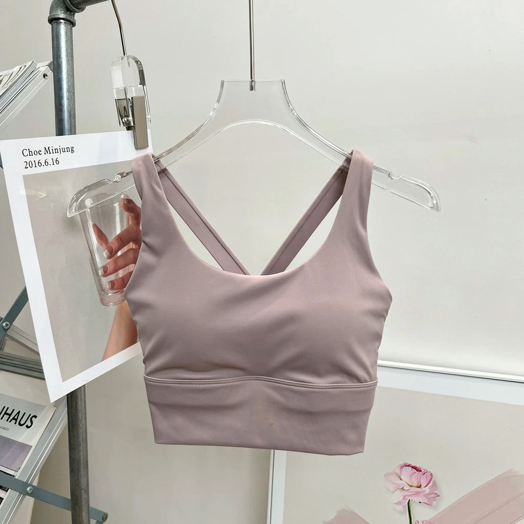 Light purple tank top on a hanger against a white background