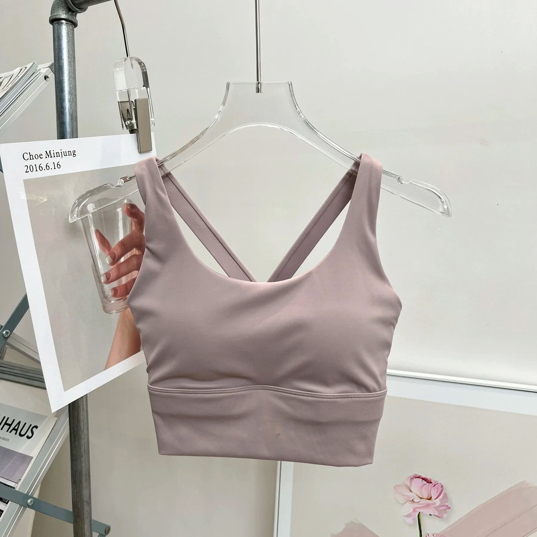 Light purple tank top on a hanger against a white background