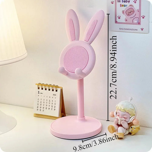 Pink bunny-shaped lamp on a white surface with measurements displayed.