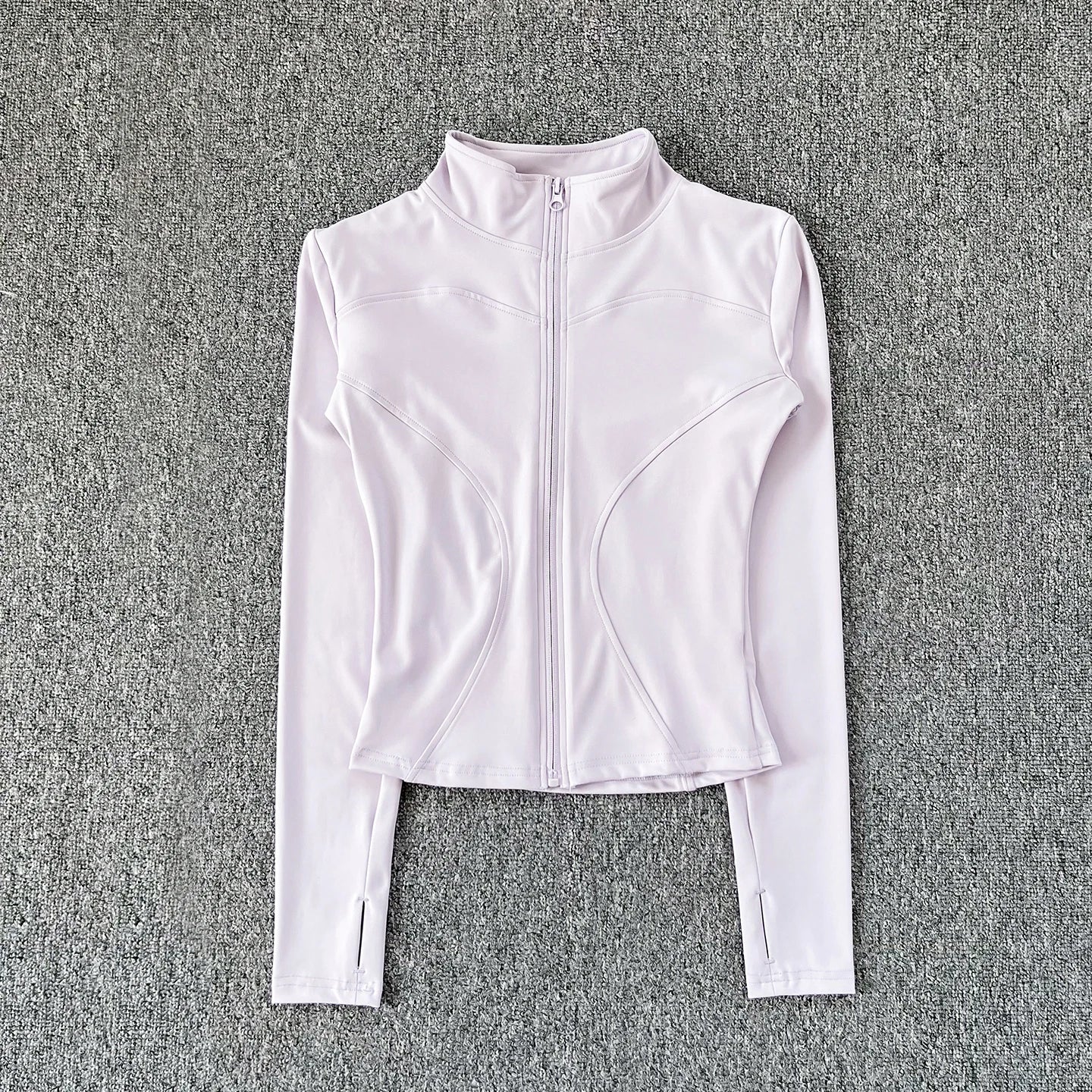 White zip-up athletic jacket on a gray textured background